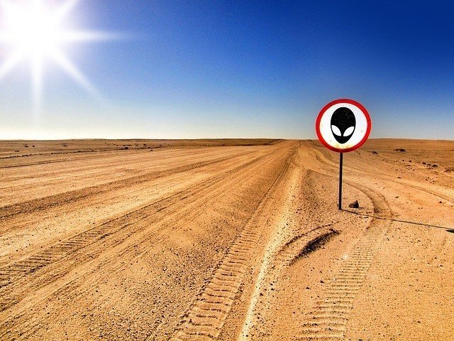 A desert, a road and a road sign, an access ban, with the image of an alien face inside the red circle. Why is area 51 so top secret?